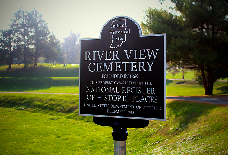 A plaque declaring River View
              Cemetery an Indiana Historical Site and listed in the National Register of Historical Places.